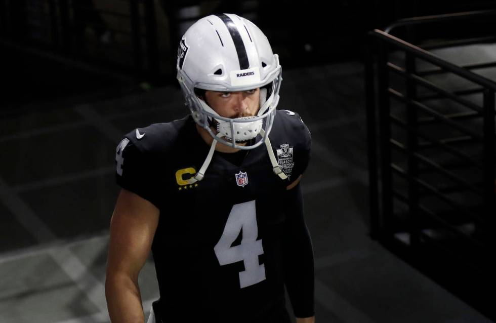 Las Vegas Raiders quarterback Derek Carr (4) walks onto the field before an NFL football game a ...