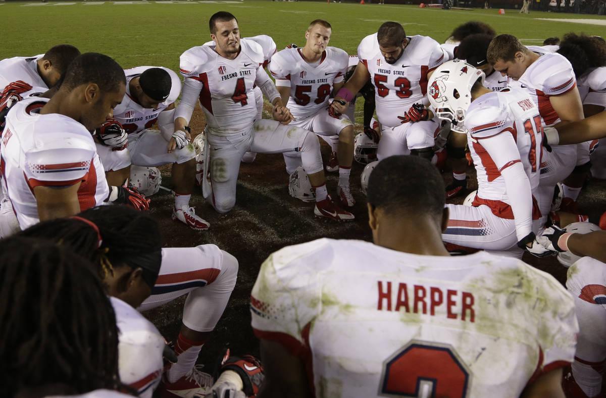 Fresno State quarterback Derek Carr (4) leads a prayer with teammates after beating San Diego S ...