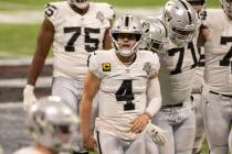 Las Vegas Raiders quarterback Derek Carr (4) jogs off the field dejected after a three-and-out ...