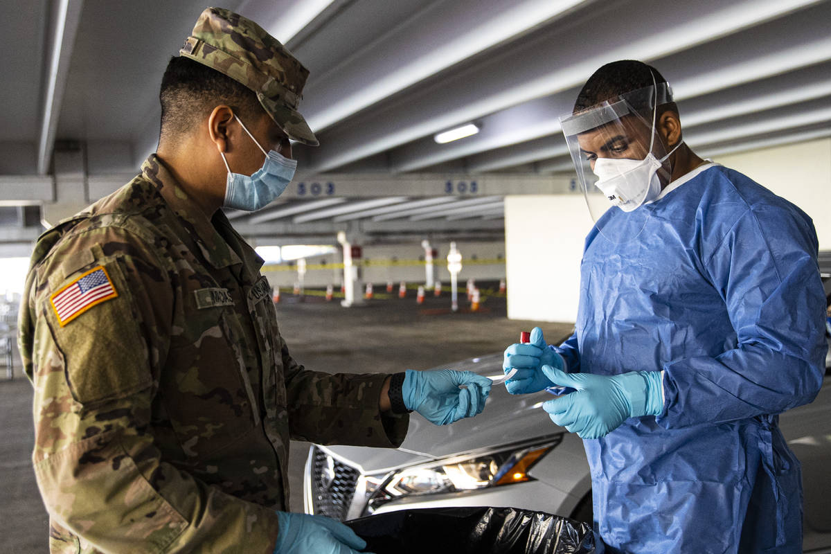 Nevada National Guard specialists Jonathan Macias, left, and Demetrie Barnett prepare to store ...