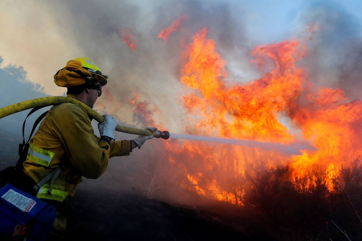 A firefighter battles the Bond Fire in Silverado, Calif., Thursday, Dec. 3, 2020. (AP Photo/Rin ...