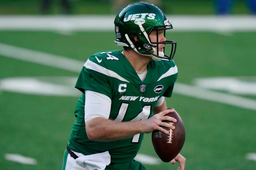 New York Jets quarterback Sam Darnold looks to throw during the first half of an NFL football g ...