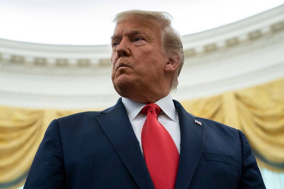 President Donald Trump listens to a question during a ceremony in the Oval Office of the White ...