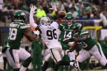 New York Jets quarterback Sam Darnold (14) throws a pass to running back Ty Montgomery (88) as ...