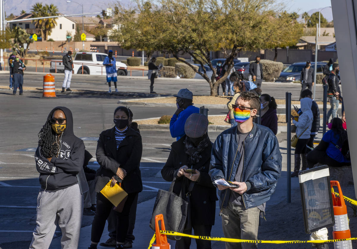 Brady Allan, right, joins others lining up outside the Nevada Department of Motor Vehicles on W ...