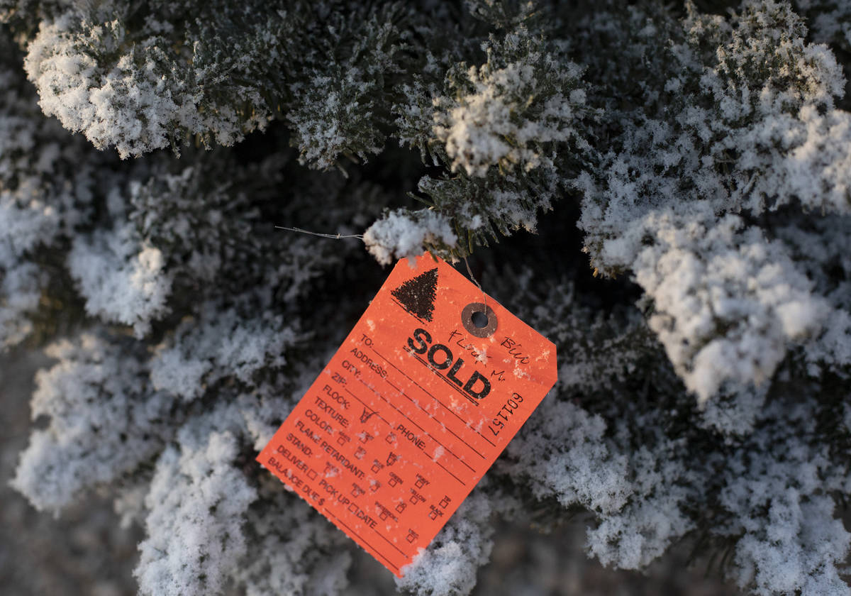 A frocked Christmas tree is marked sold at Rudolph's Christmas Trees on Saturday, Dec. 5, 2020, ...