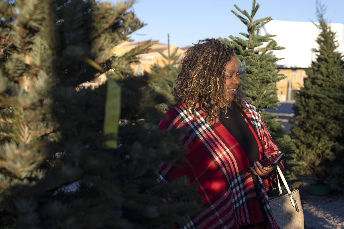 Traci Rawlinson browses for trees at Rudolph's Christmas Trees on Saturday, Dec. 5, 2020, in La ...