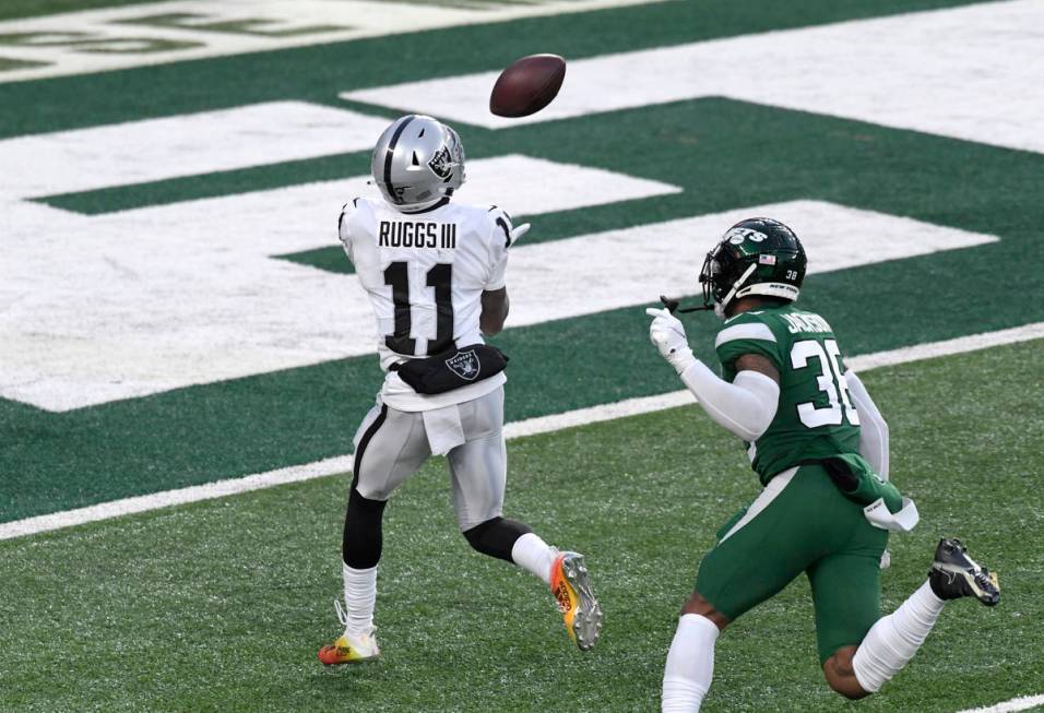 Las Vegas Raiders' Henry Ruggs III, left, catches a touchdown during the second half an NFL foo ...