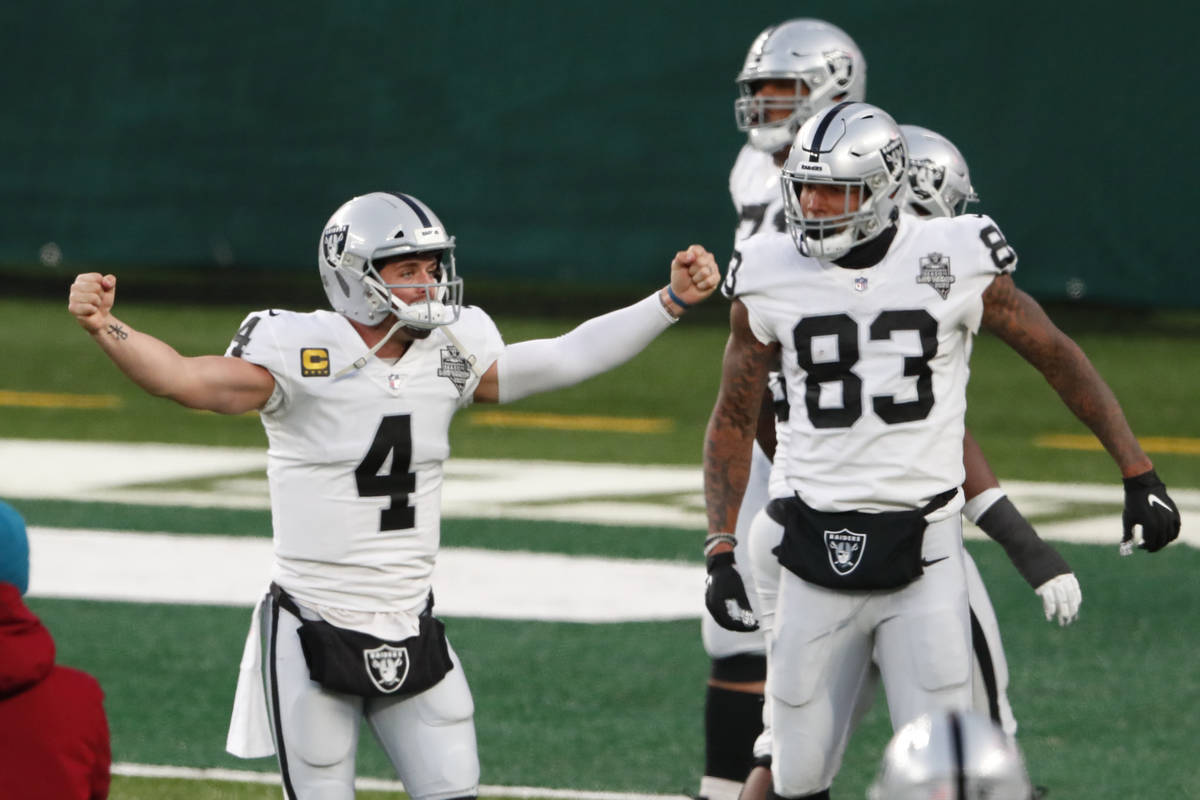 Las Vegas Raiders quarterback Derek Carr (4) celebrate after throwing a touchdown pass to Henry ...