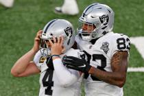 Las Vegas Raiders quarterback Derek Carr (4) reacts after throwing a game winning touchdown pas ...