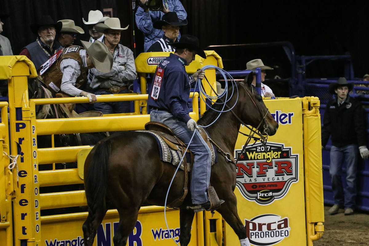 Charly Crawford of Prineville, Ore. rides away after the team roping event during the third nig ...