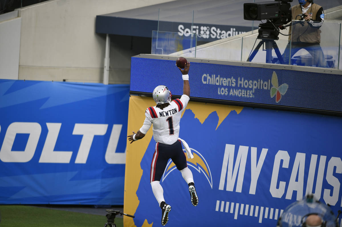 New England Patriots quarterback Cam Newton (1) celebrates after scoring against the Los Angele ...