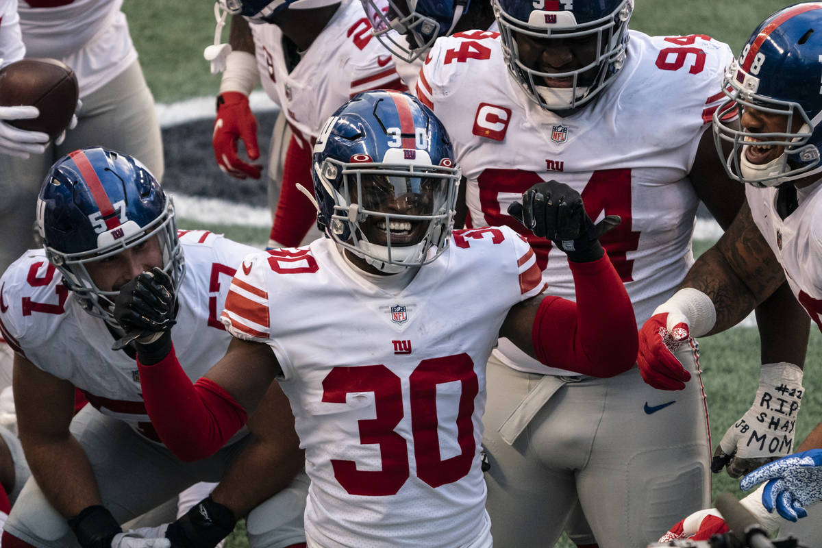 New York Giants defensive back Darnay Holmes (30) celebrates with teammates after making an int ...