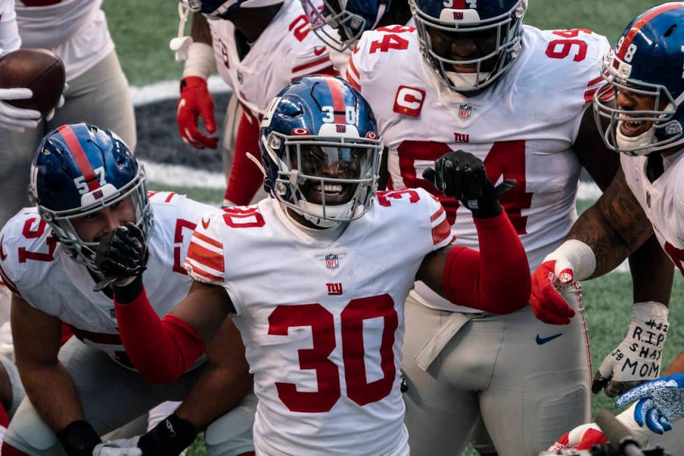 New York Giants defensive back Darnay Holmes (30) celebrates with teammates after making an int ...