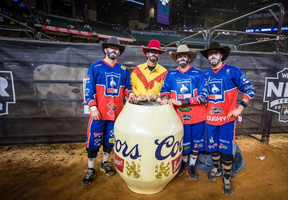 Clowns are seen during the 4th go-round of the National Finals Rodeo in Arlington, Texas, on Su ...