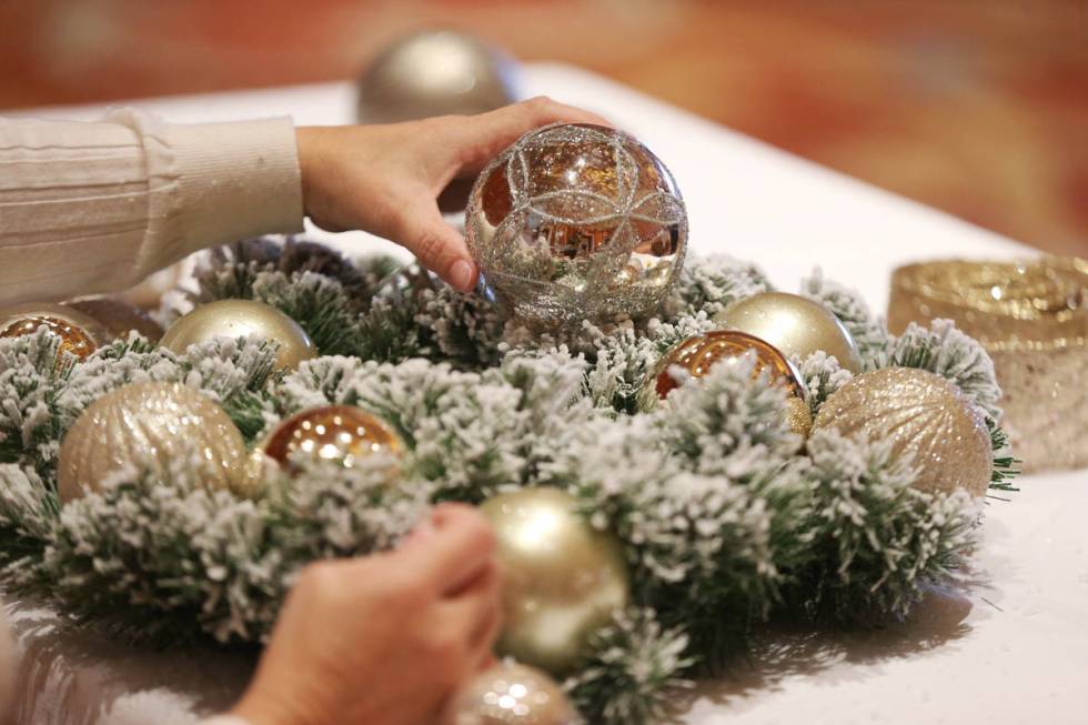 Sylvia Sanchez of Brownsville, Texas, works on her wreath during the Mastering Holiday Wreaths ...