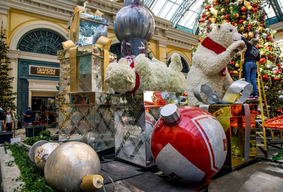 Artist Natalie Tremayne touches up the eye of a Coca-Cola polar bear about the new winter displ ...