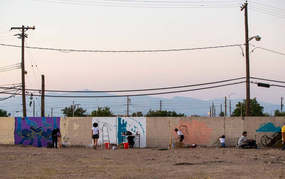 Artists work on murals at the site of the former Moulin Rouge in Las Vegas on Saturday, Oct. 3, ...