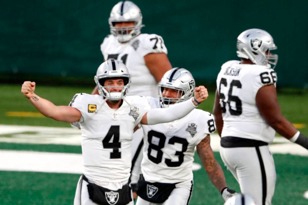 Las Vegas Raiders quarterback Derek Carr (4) celebrate after throwing a touchdown pass to Henry ...