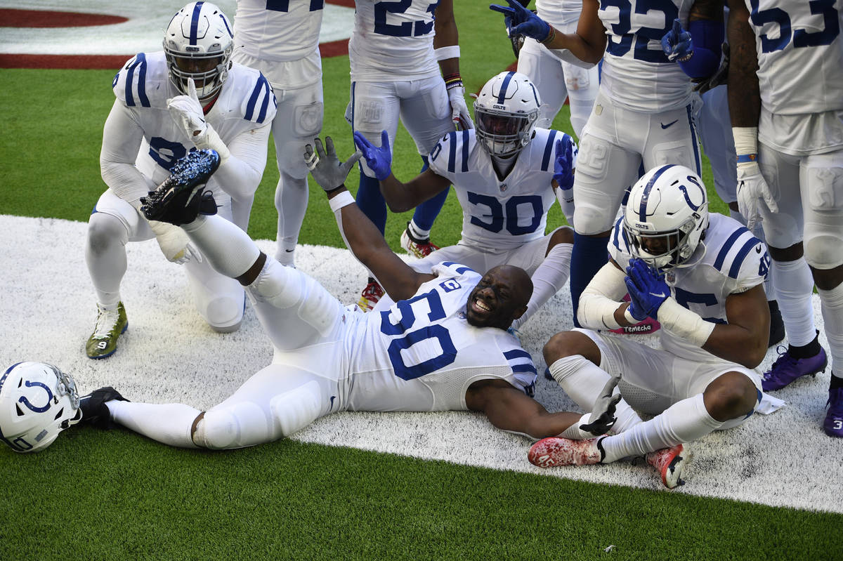 Indianapolis Colts defensive end Justin Houston (50) and teammates celebrate a fumble recovery ...