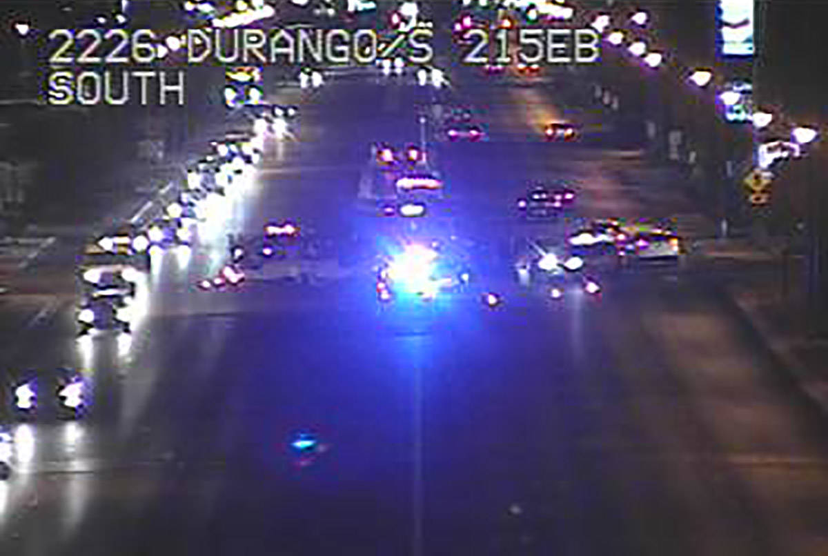 Law enforcement officers investigate an injury crash at South Durango Drive and the 215 Beltway ...