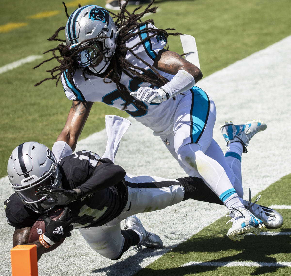 Las Vegas Raiders wide receiver Henry Ruggs III (11) collides with Carolina Panthers safety Tre ...