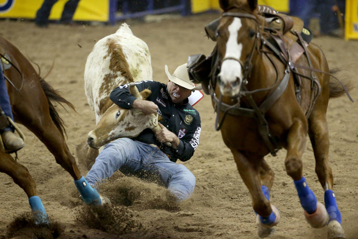 Matt Reeves of Cross Plains, Texas competes in the Steer Wrestling competition in the first go- ...