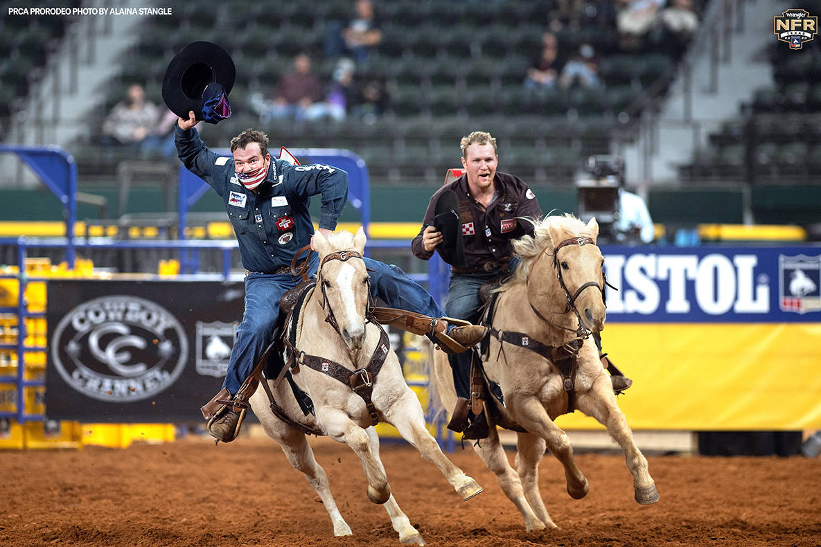 Steer wrestlers Jacob Edler and Stetson Jorgensen celebrate their first-place performance on Tu ...