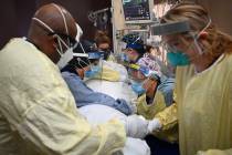 In a Monday, Dec. 7, 2020, file photo, critical care nurses and respiratory therapists flip a p ...