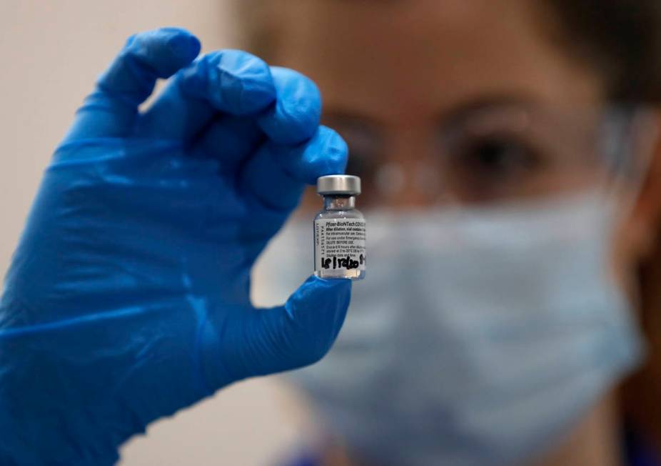 A nurse holds a phial of the Pfizer-BioNTech COVID-19 vaccine at Guy's Hospital in London, Tues ...