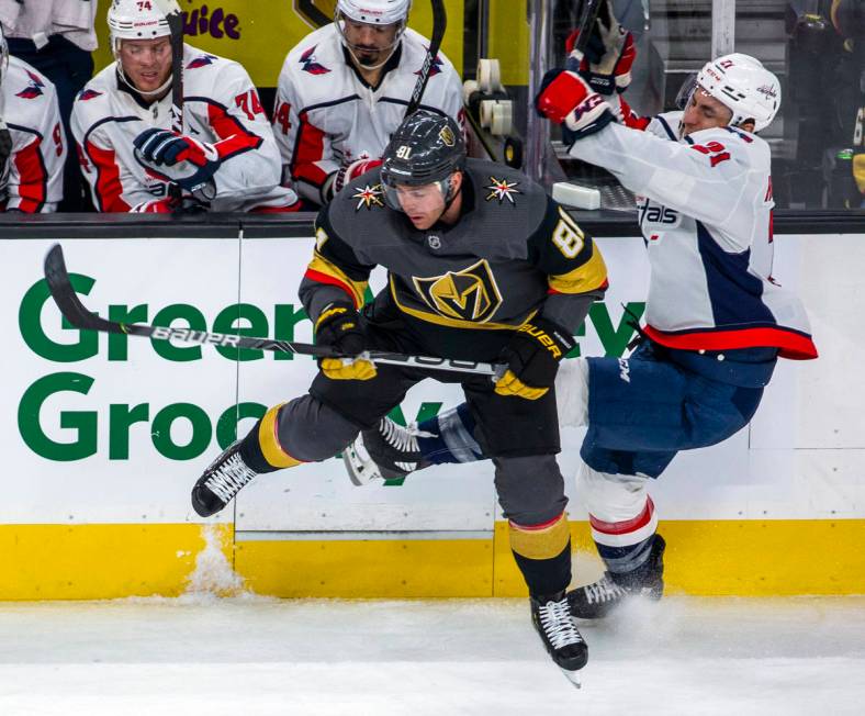 Vegas Golden Knights center Jonathan Marchessault (81, left) collides with Washington Capitals ...