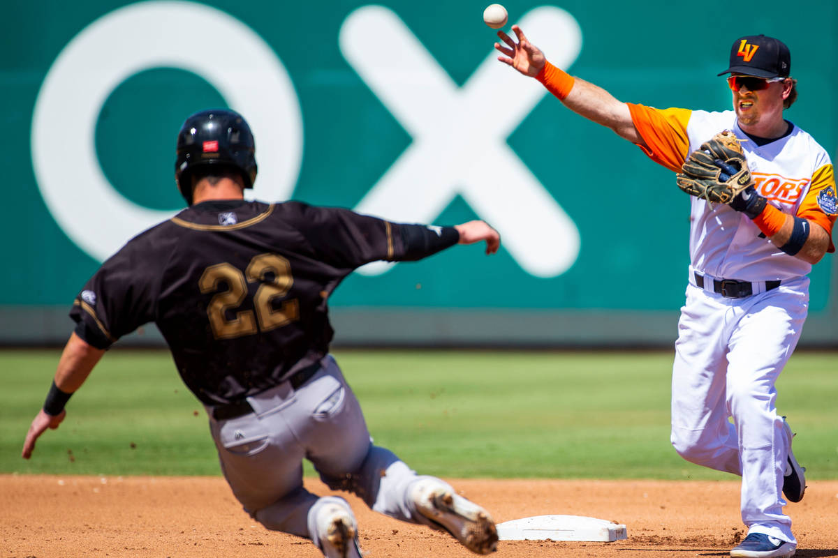 Las Vegas Aviators second baseman Trace Loehr (7, right) makes the out in the third inning on S ...