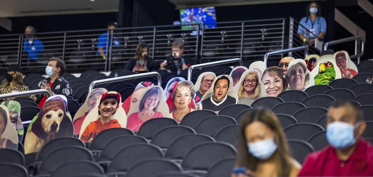 Fans are surrounded by cardboard cut outs in the stands before the first half of the UNLV Rebel ...