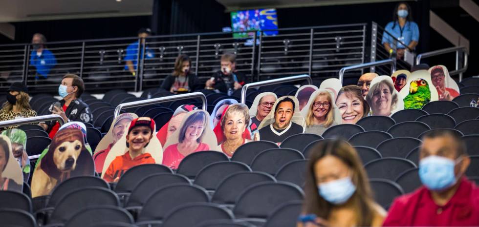 Fans are surrounded by cardboard cut outs in the stands before the first half of the UNLV Rebel ...