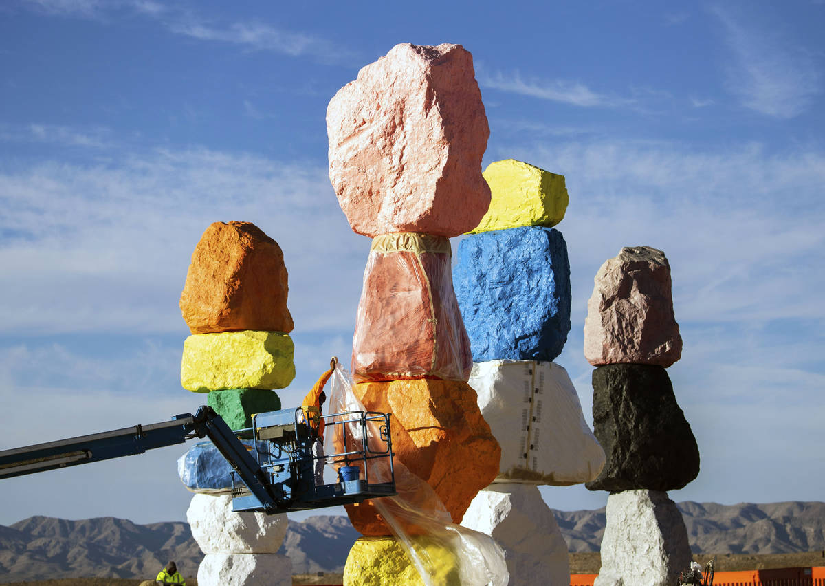Lorenzo Padia of Vergith Contracting Co. begins prepping the Seven Magic Mountains totems for p ...
