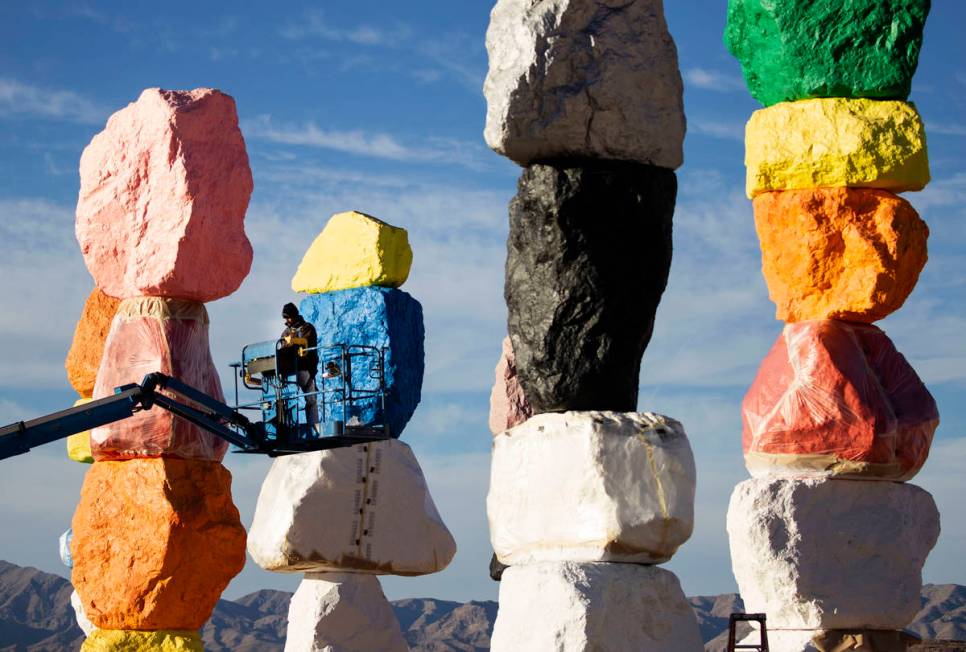 Lorenzo Padia of Vergith Contracting Co. begins prepping the Seven Magic Mountains totems for p ...