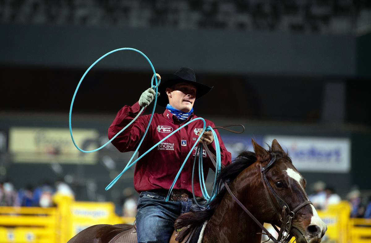 Crawford Medlin rides during the 7th go-round of the National Finals Rodeo in Arlington, Texas, ...