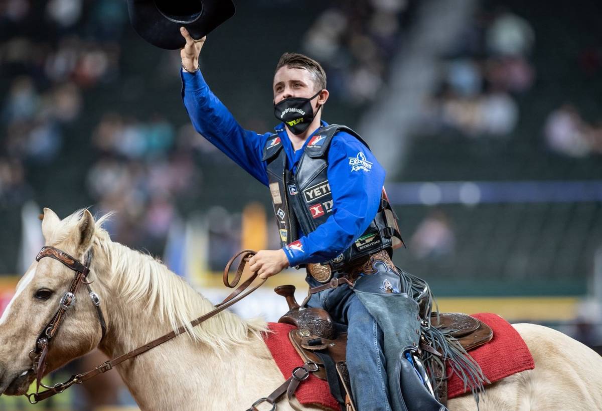 Stetson Wright waves during the 7th go-round of the National Finals Rodeo in Arlington, Texas, ...