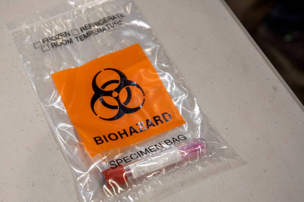 A completed COVID-19 test is seen in a biohazard bag during a preview of COVID-19 testing site ...