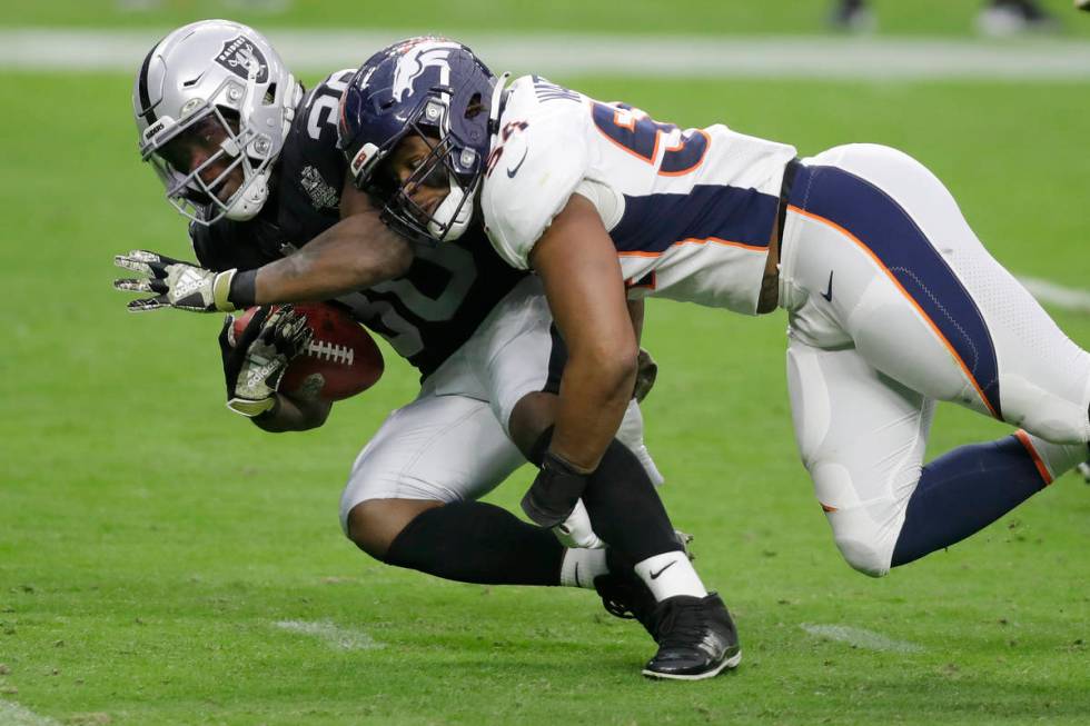 Denver Broncos linebacker Josh Watson (54) tackles Las Vegas Raiders running back Jalen Richard ...