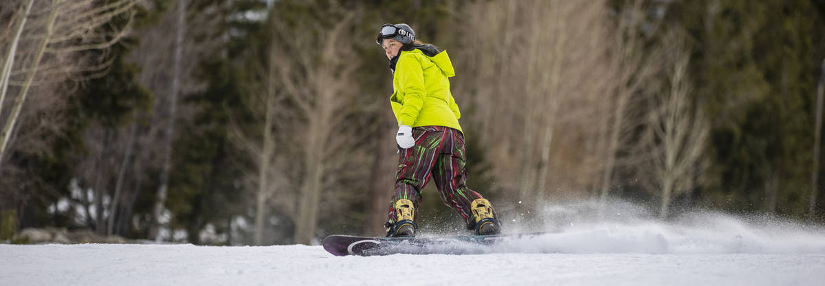 Snowboarder Miranda Hammer of Las Vegas glides down the run near the lodge during opening day o ...