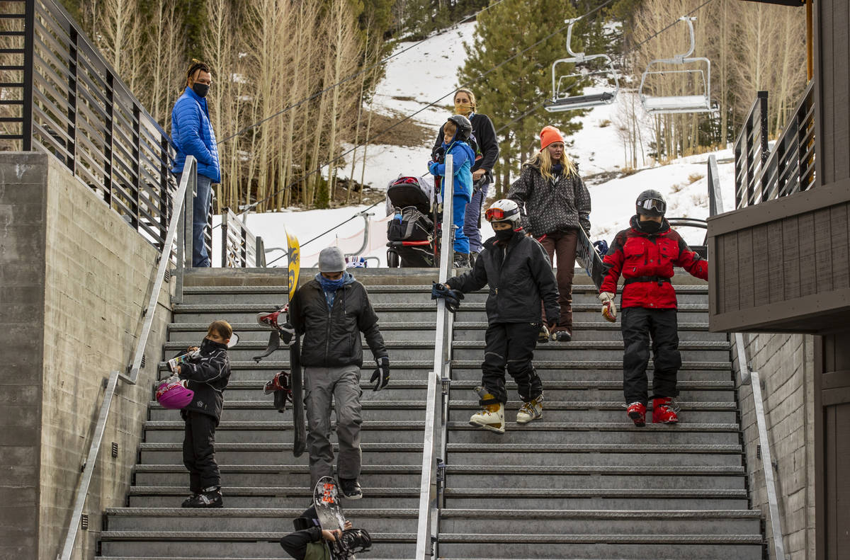 People carefully navigate the stairs leading from the lodge during opening day of skiing and sn ...