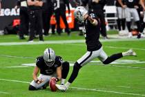 Las Vegas Raiders kicker Daniel Carlson (2) and Las Vegas Raiders A.J. Cole (6) during an NFL f ...