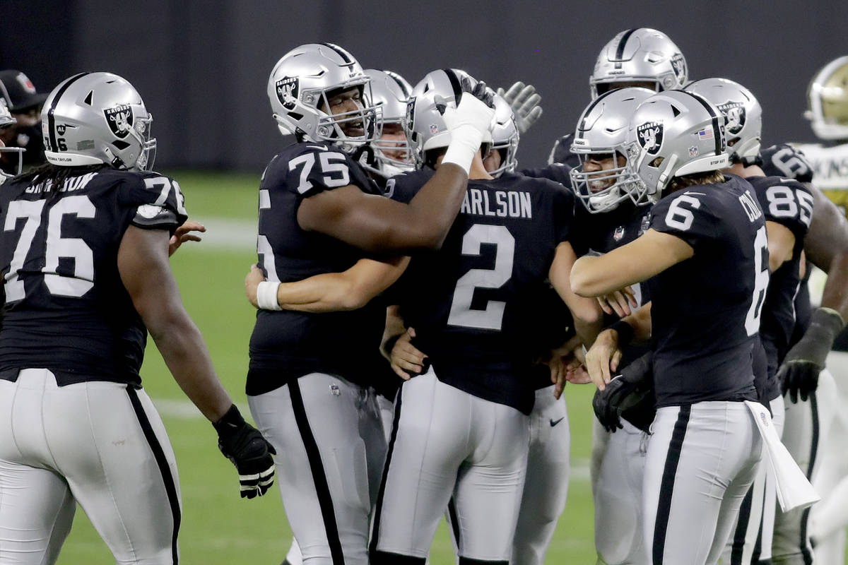 Las Vegas Raiders players celebrate after kicker Daniel Carlson (2) scored a 54 yard field goal ...