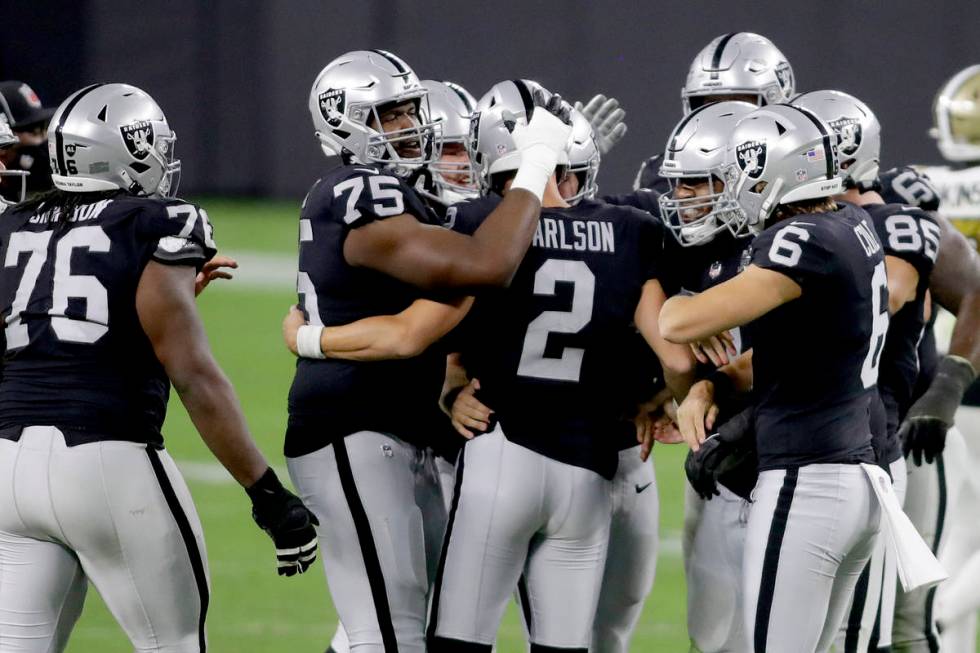 Las Vegas Raiders players celebrate after kicker Daniel Carlson (2) scored a 54 yard field goal ...