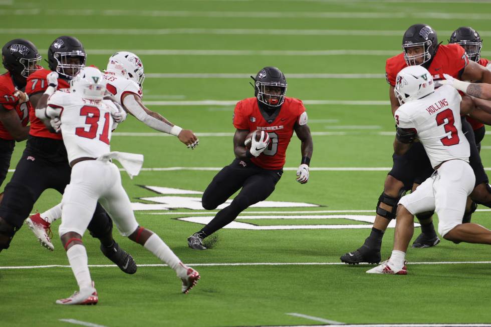 UNLV Rebels running back Charles Williams (8) runs the ball against the Fresno State Bulldogs d ...