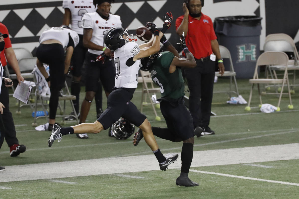 UNLV defensive back Daniel Walden (37) breaks up a pass intended for Hawaii wide receiver Melqu ...