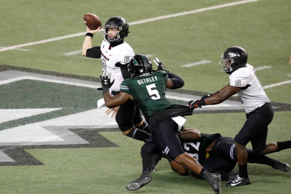 UNLV quarterback Max Gilliam (6) throws the ball away before being sacked by Hawaii defensive b ...