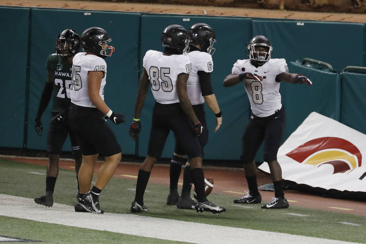 UNLV running back Charles Williams (8) performs a mock hula dance after scoring a touchdown aga ...