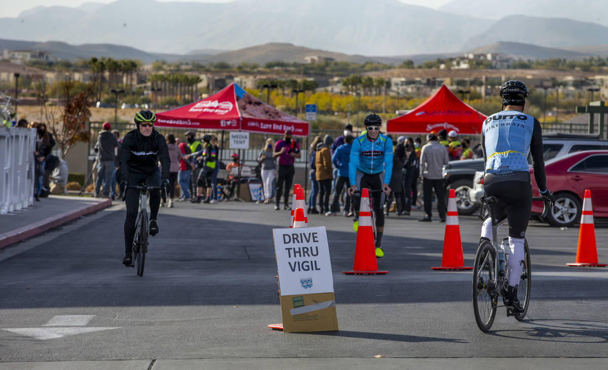 Cyclists stream about during a vigil honoring the lives of five Las Vegas cyclists who lost the ...